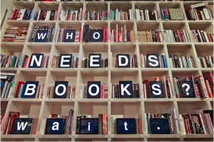 A grid of private library shelves with facing letters that spell out: "Who needs books? Wait..."